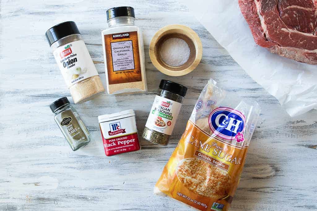 Ingredients to make pot roast seaonsoning laid on a white surface.