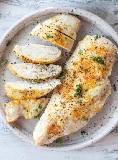 sliced and whole chicken breast on plate