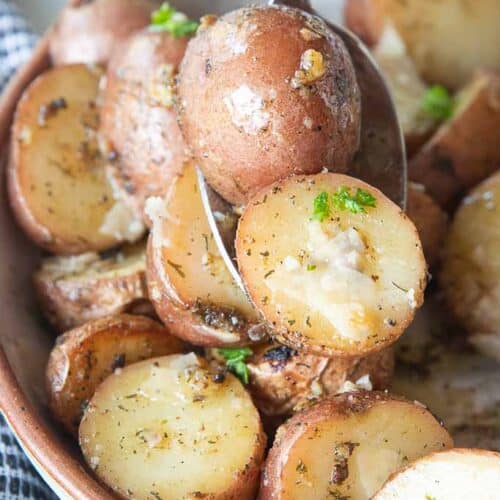 spoon scooping up red potatoes from bowl
