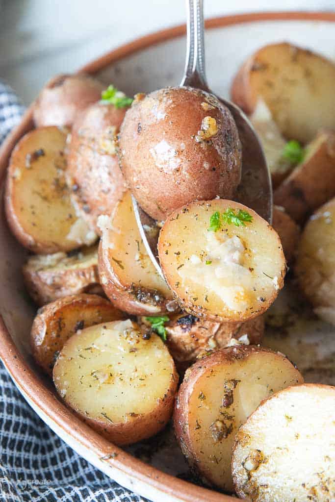 spoon scooping up red potatoes from bowl