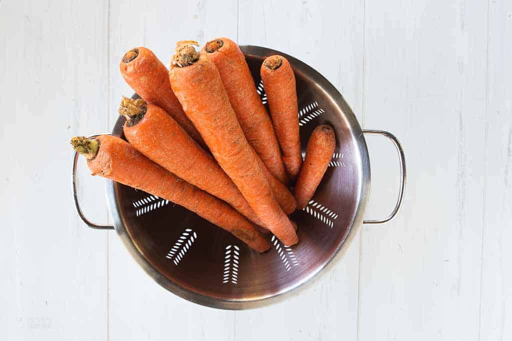 fresh whole carrots in a colander