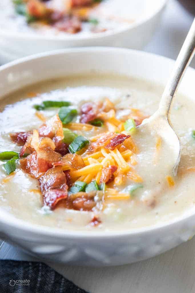 loaded potato soup in bowl with spoon