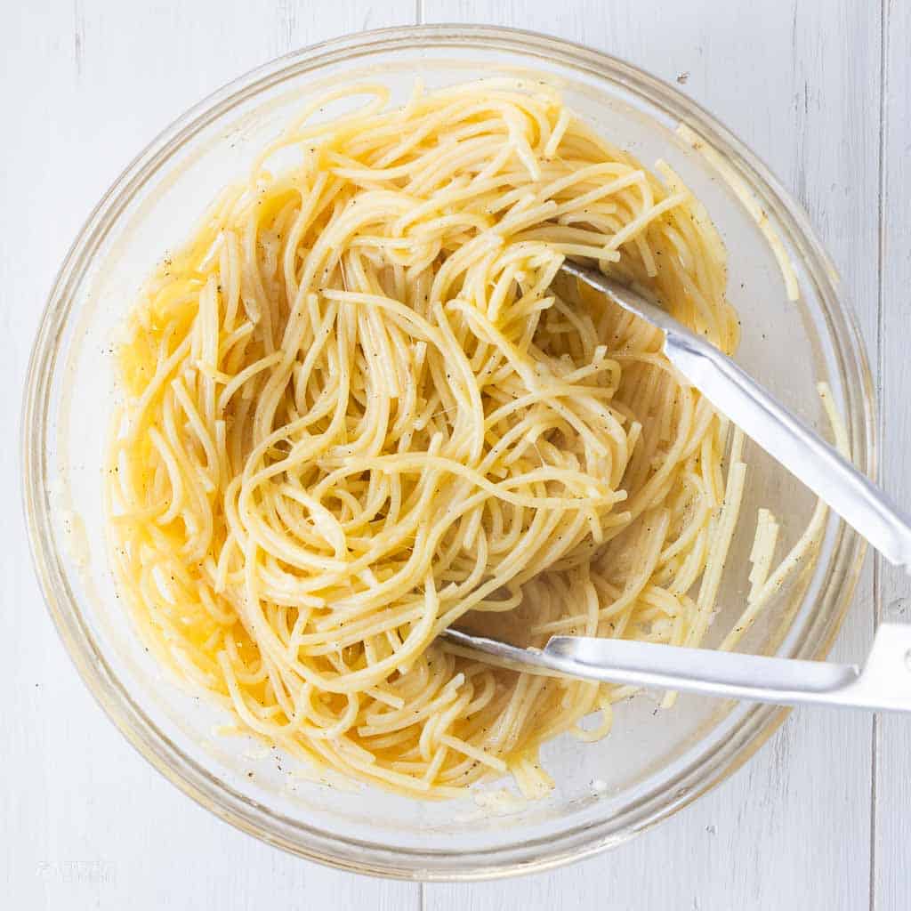 spaghetti noodles tossed in mixing bowl