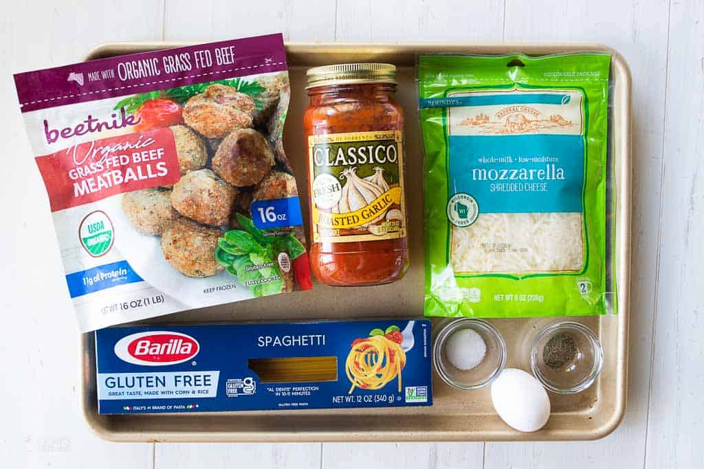 ingredients for spaghetti an meatball cups on sheet pan