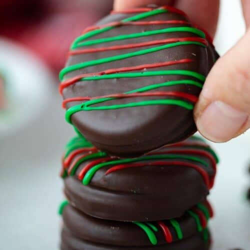 hand holding chocolate covered Oreo