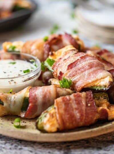 bacon wrapped jalapeno poppers on a plate
