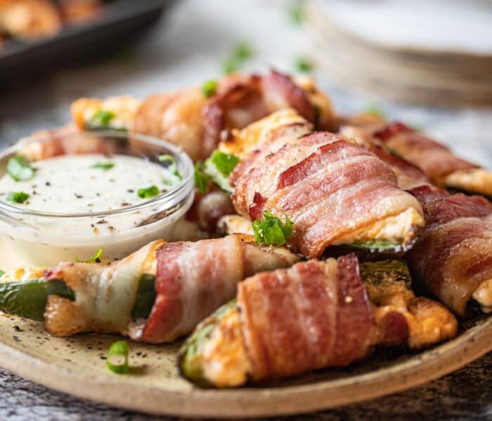 bacon wrapped jalapeno poppers on a plate