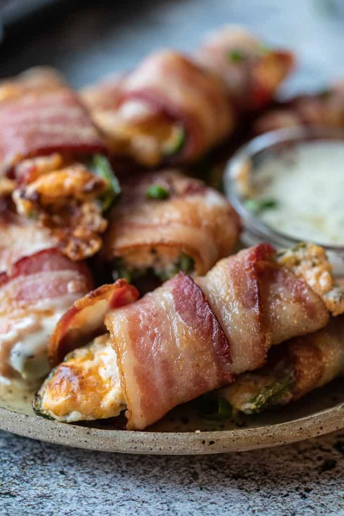 air fryer jalapeno poppers stacked on a plate