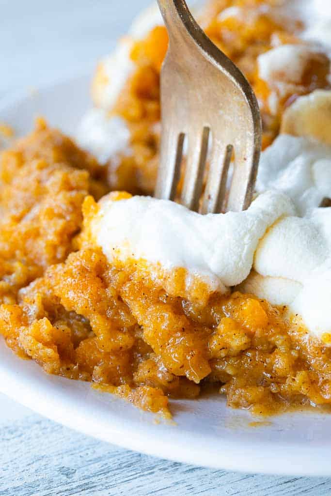 fork scooping into sweet potato casserole