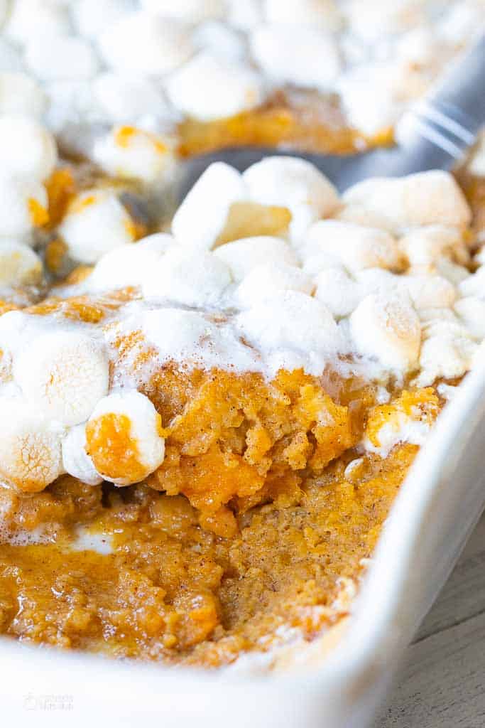 spoon scooping a serving of sweet potato casserole