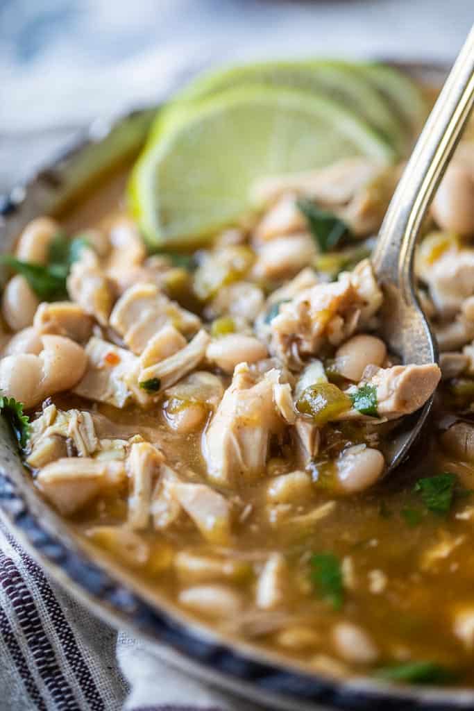 spoon in bowl of green Chili chicken soup