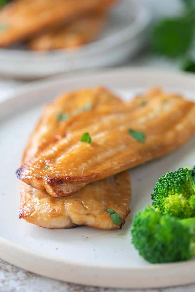 broiled fish on plate with broccoli