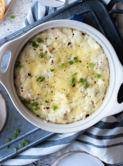 cheesy crab artichoke dip in serving bowl