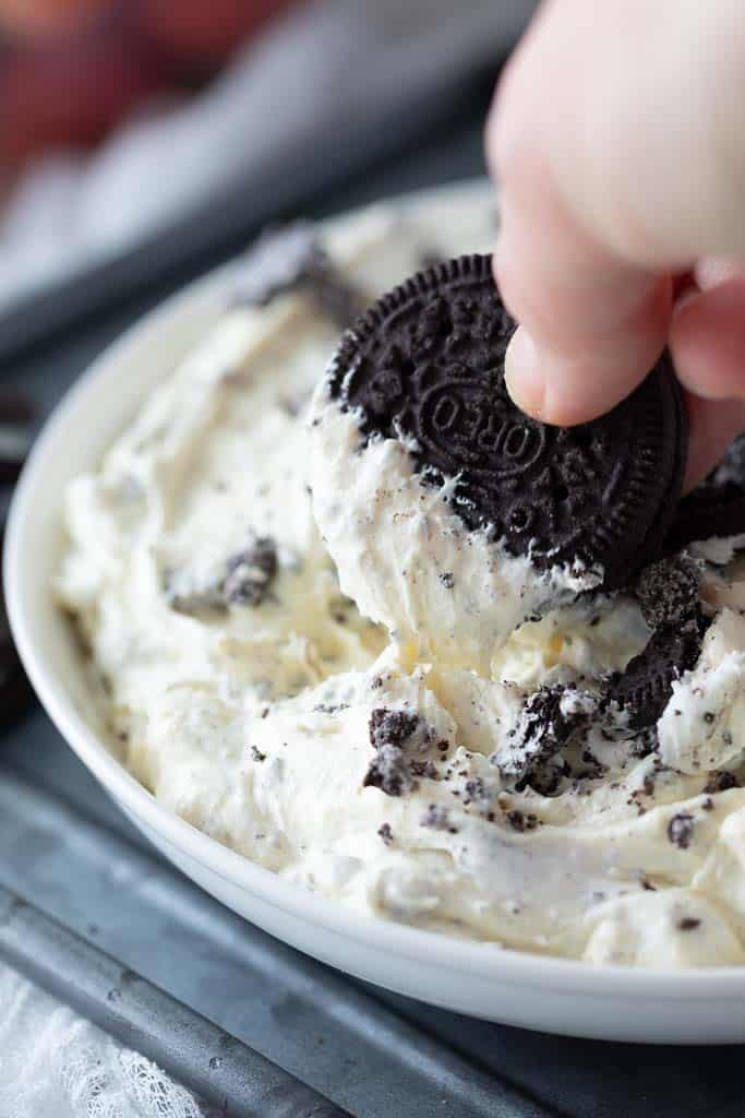 Oreo cookie dipped in creamy dip