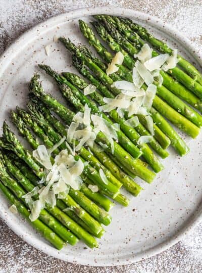 air fried asparagus on a plate with parmesan cheese