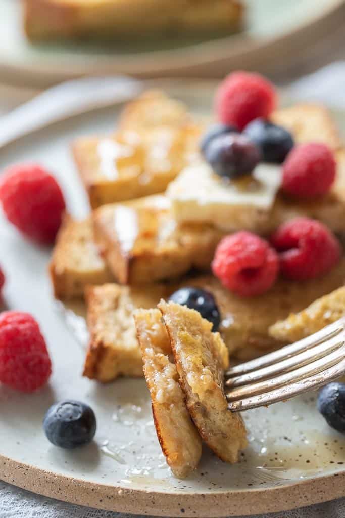 fork scooping bite of gluten free French toast sticks