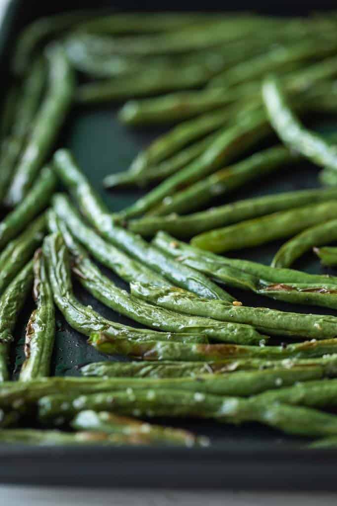 crispy green beans on an air fryer tray