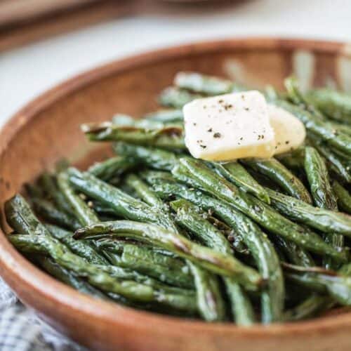 air fryer green beans in a bowl with butter