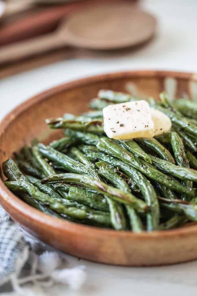 air fryer green beans in a bowl with butter