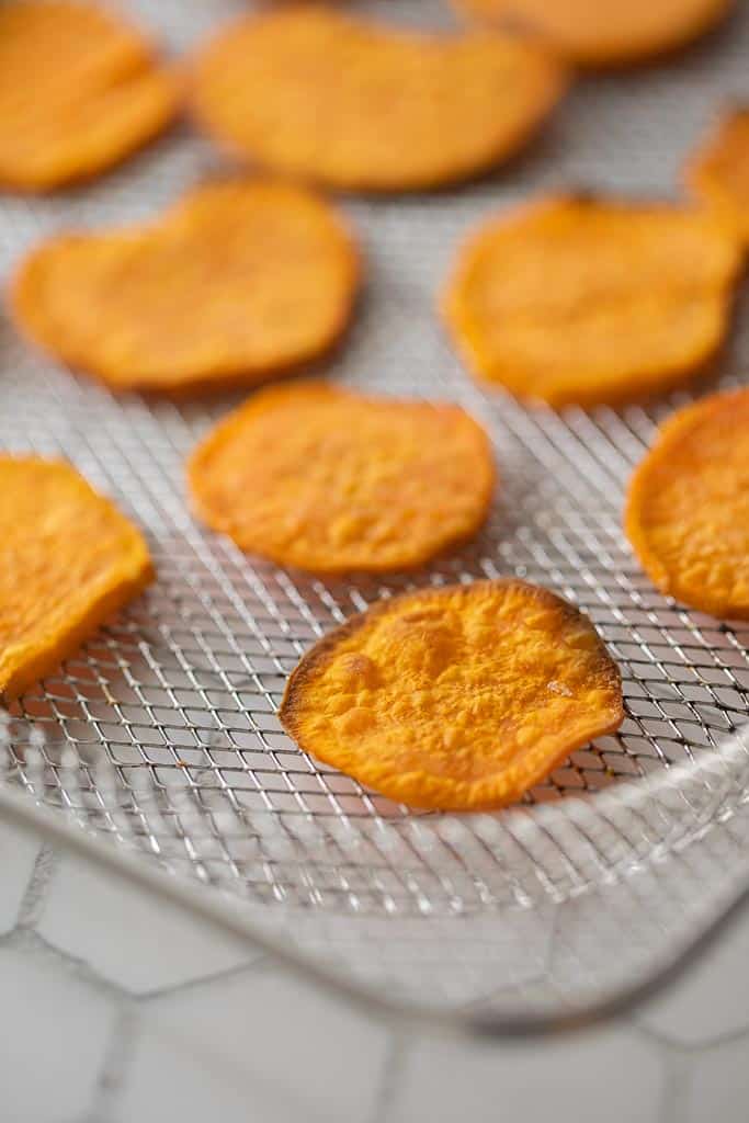 sweet potato chips on an air fryer tray