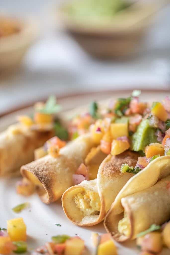 air fryer taquitos topped with fresh salsa