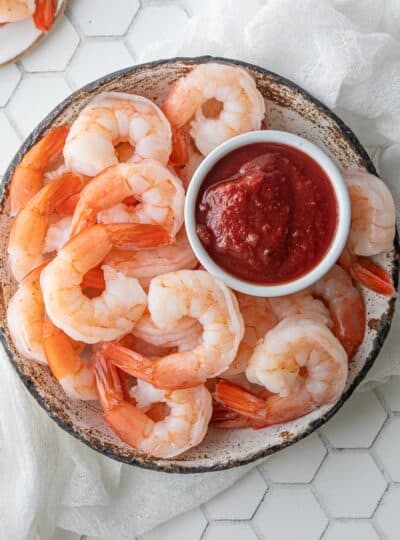 boiled shrimp in a bowl with cocktail sauce