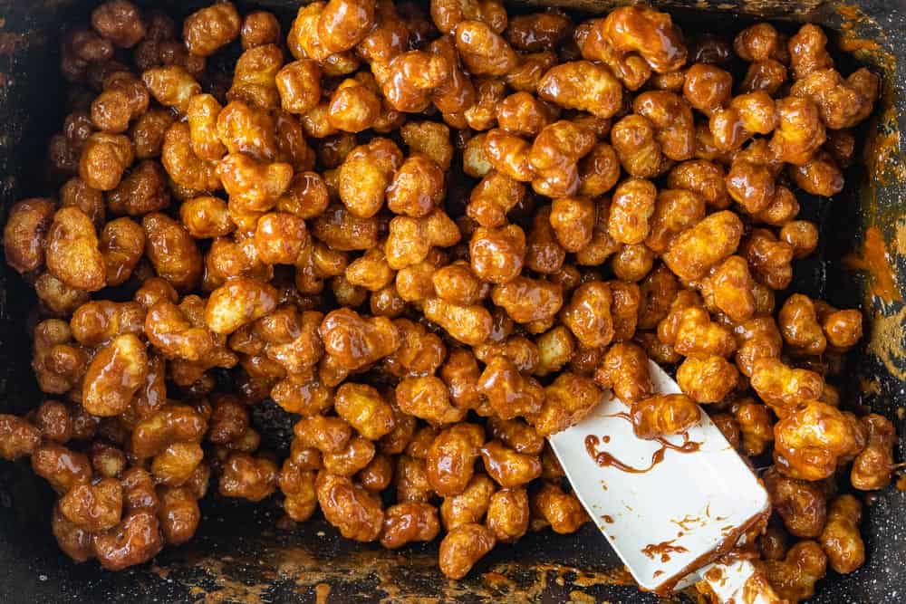 caramel puff corn mixed with spatula