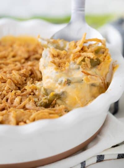 close up view of spoon scooping green bean casserole