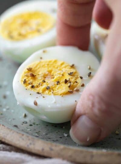 hand picking up seasoned hard boiled egg