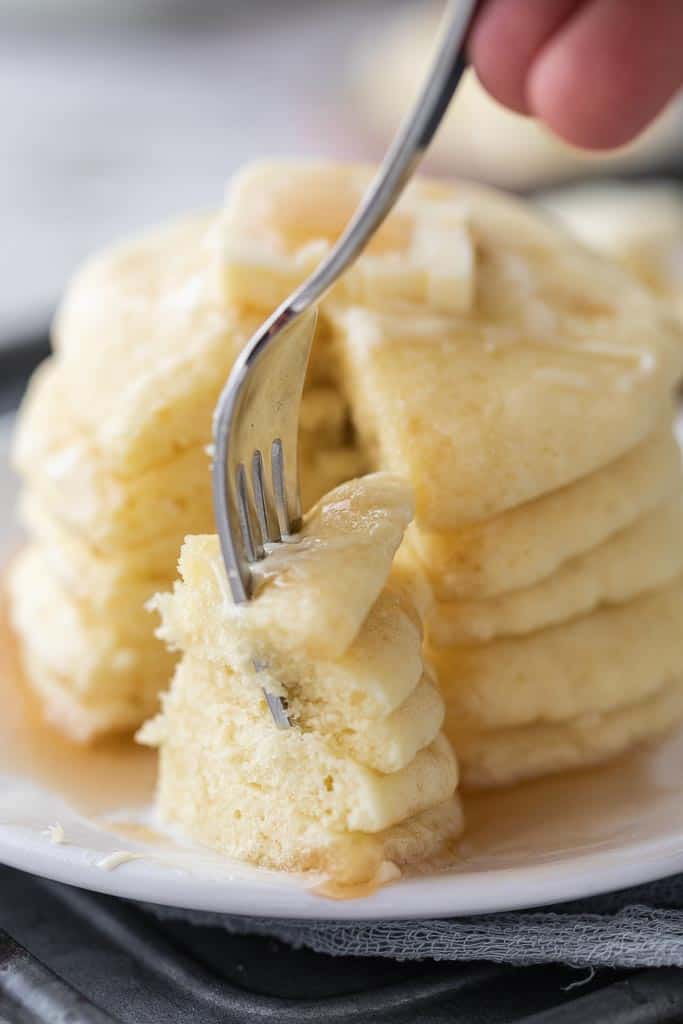 fork scooping into stacked pancakes