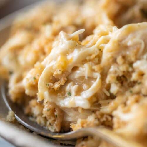 spoon scooping chicken and stuffing casserole