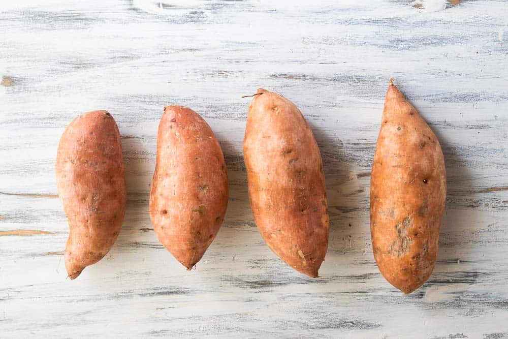 four sweet potatoes on counter