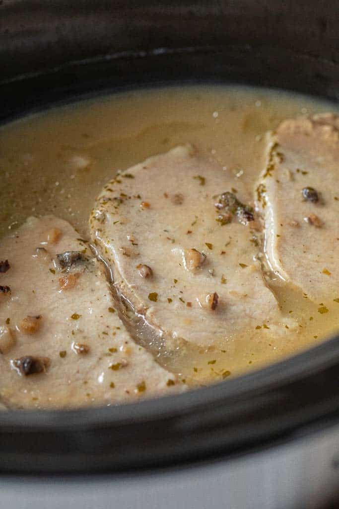 pork chops simmering in cream of mushroom soup