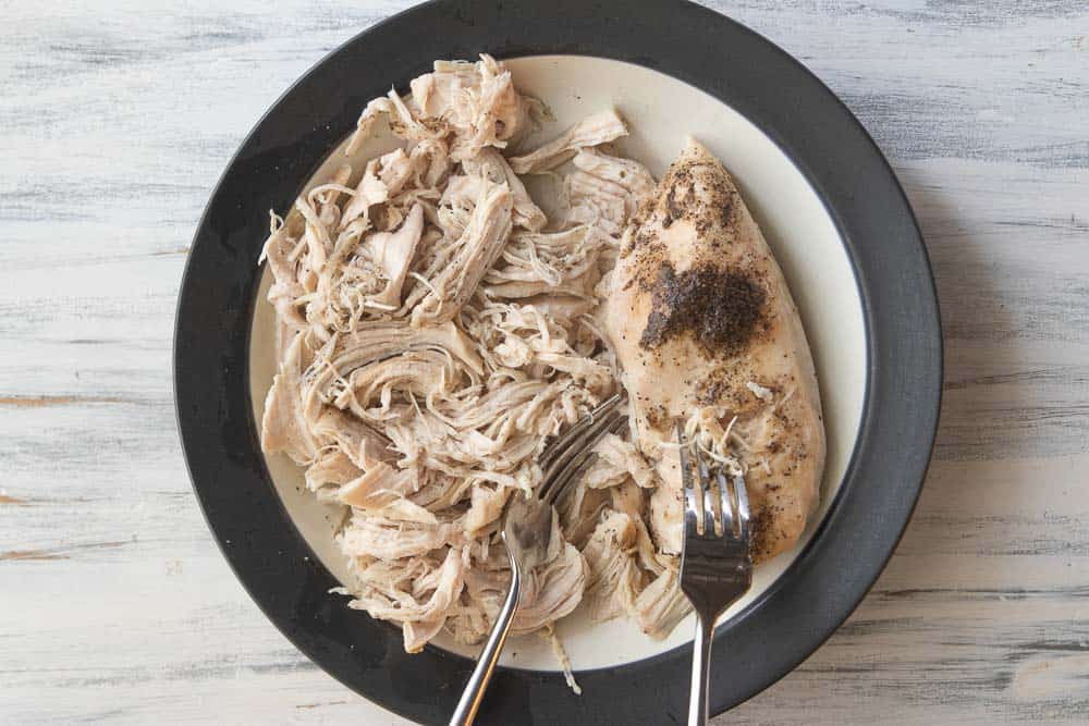 chicken shredded in bowl with forks