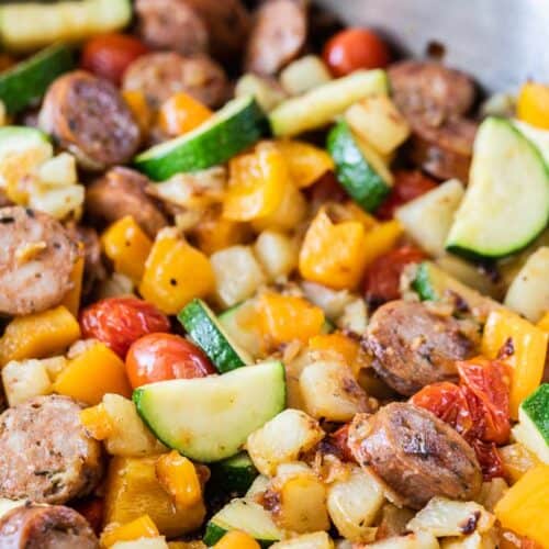 cooked vegetables and sliced sausage in skillet