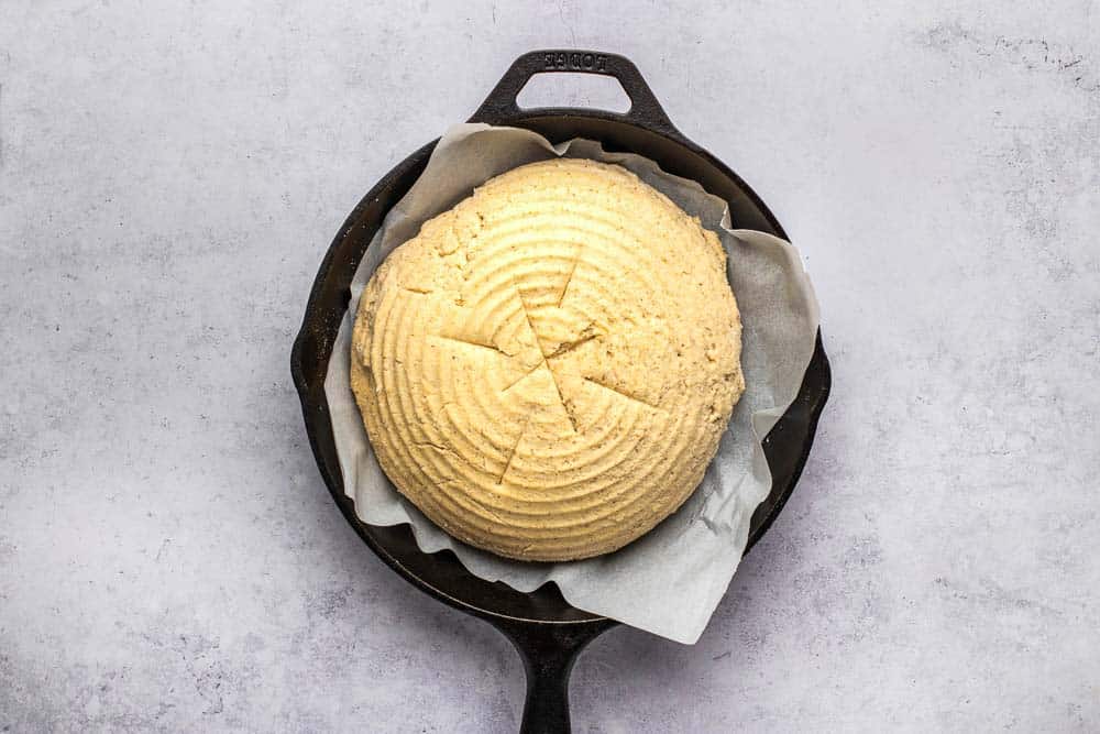 loaf of artisan bread in cast iron pan