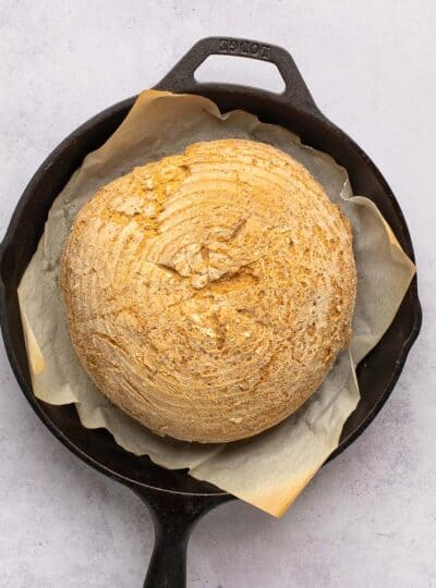 loaf of artisan bread in cast iron pan