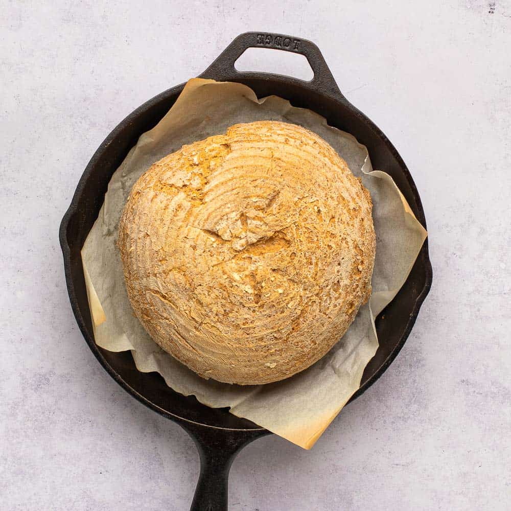 loaf of artisan bread in cast iron pan