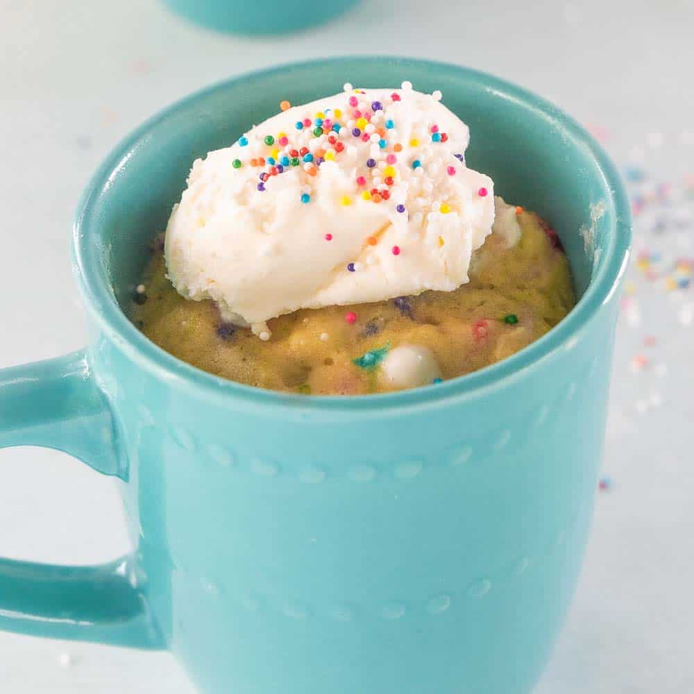Gluten free mug cake shown in a blue mug.