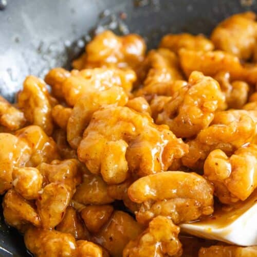 Gluten-free orange chicken in a wok.