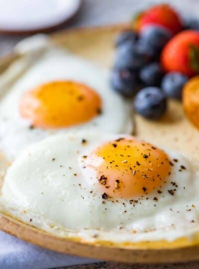 sunny side up eggs on plate with berries