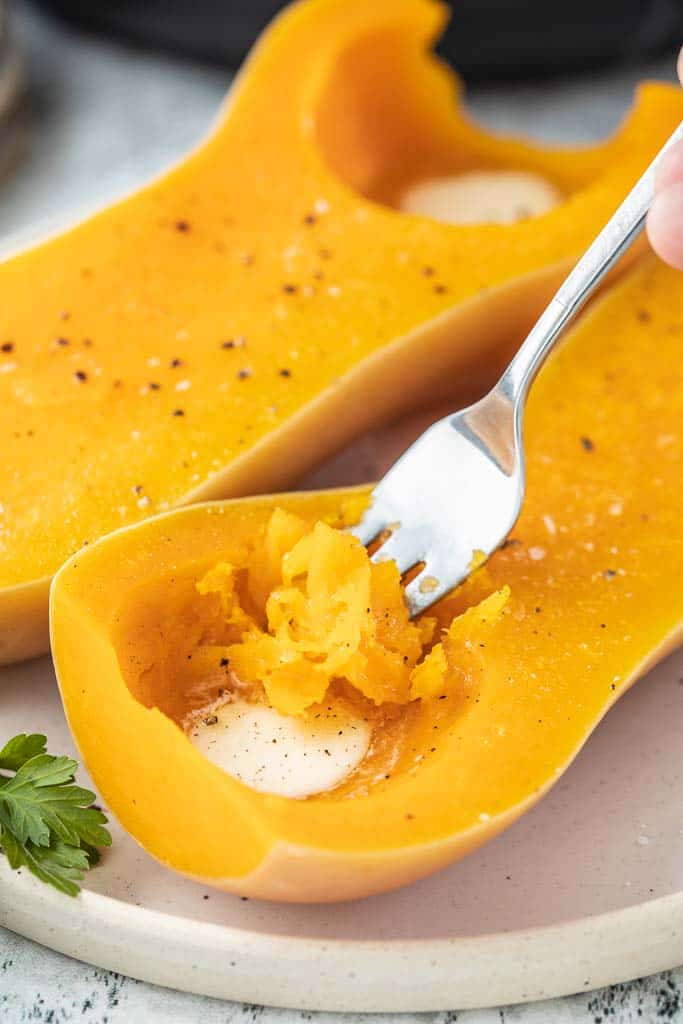 fork scooping into cooked butternut squash