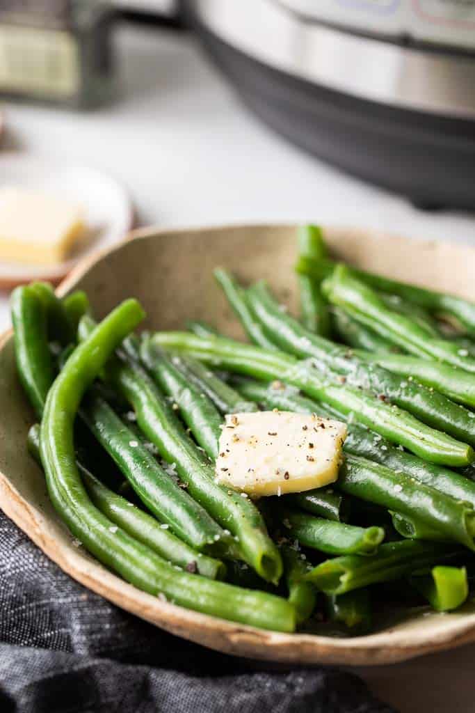 steamed green beans topped with butter