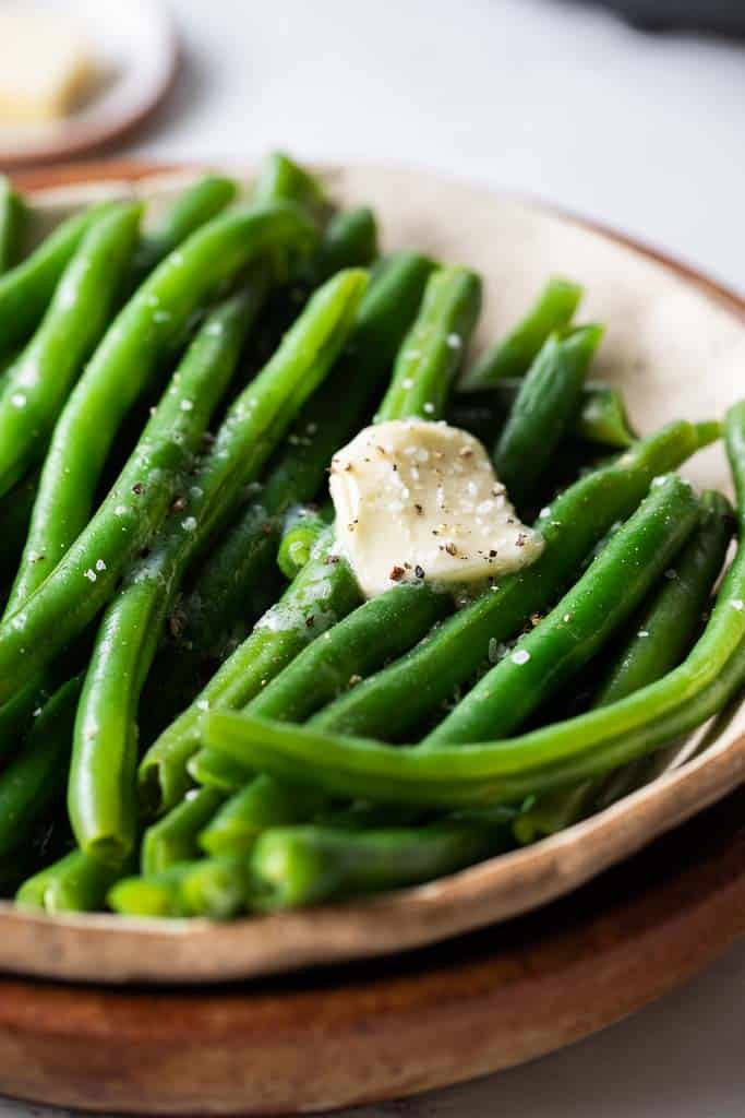 green beans in bowl topped with butter
