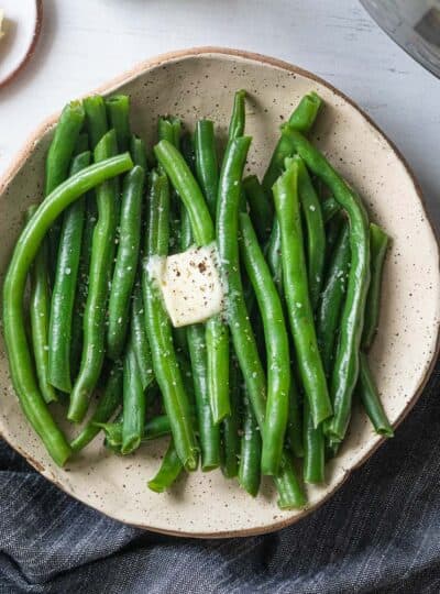 top down shot of steamed green beans with butter