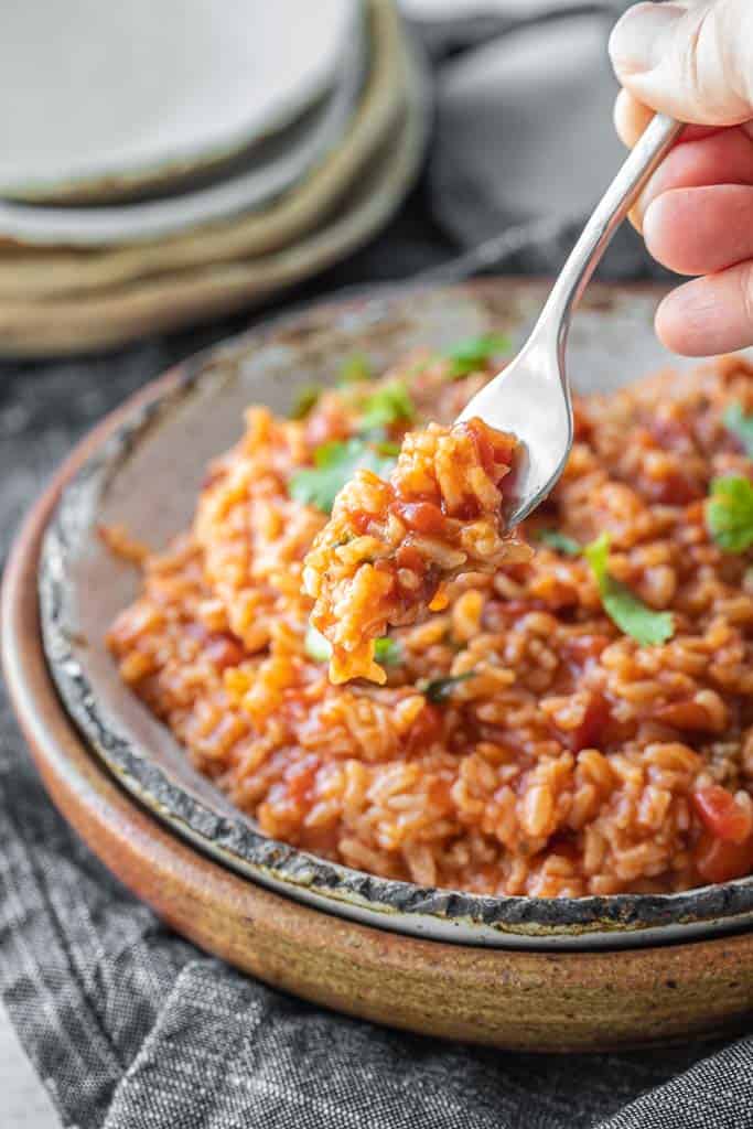 fork scooping into mexican rice