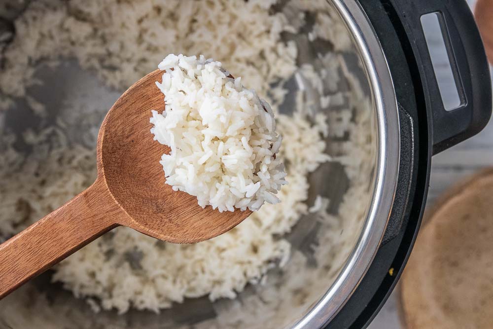 wooden spoon scooping rice from instant pot
