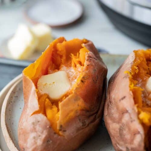 two sliced sweet potatoes topped with butter