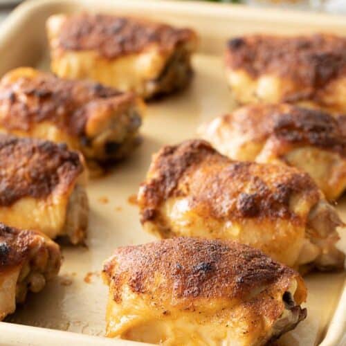 cooked chicken thighs on sheet pan