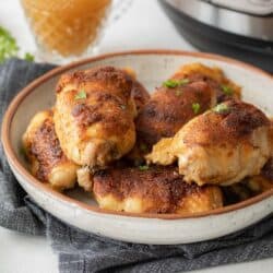 close up view of crispy chicken thighs in dish